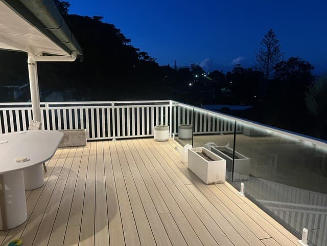 Elevated deck with LED railing accent lighting at dusk