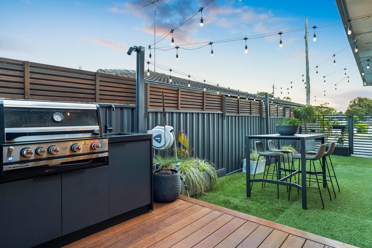 Outdoor entertainment and BBQ area with string lights